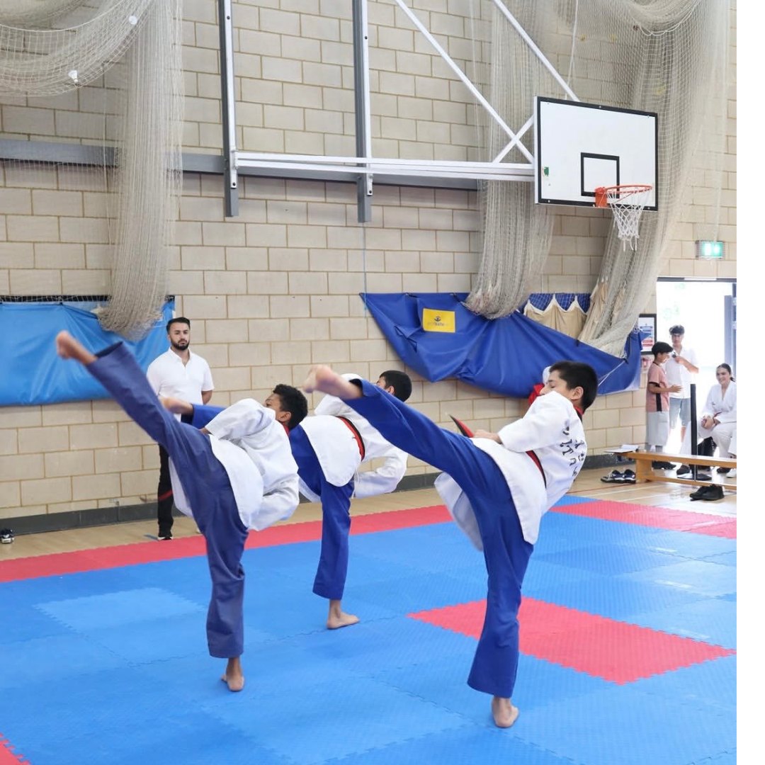 Cadets practising high side kicks in sparring kit